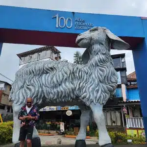 Giant sheep sculpture at Guatapé town center Colombia with zócalos buildings in background