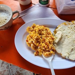 Arepa paisa with cheese — traditional street food in Medellín Colombia" -->
