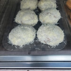 Colombian sweet street food in Medellin bolitas de coco coconut balls traditional dessert display case
